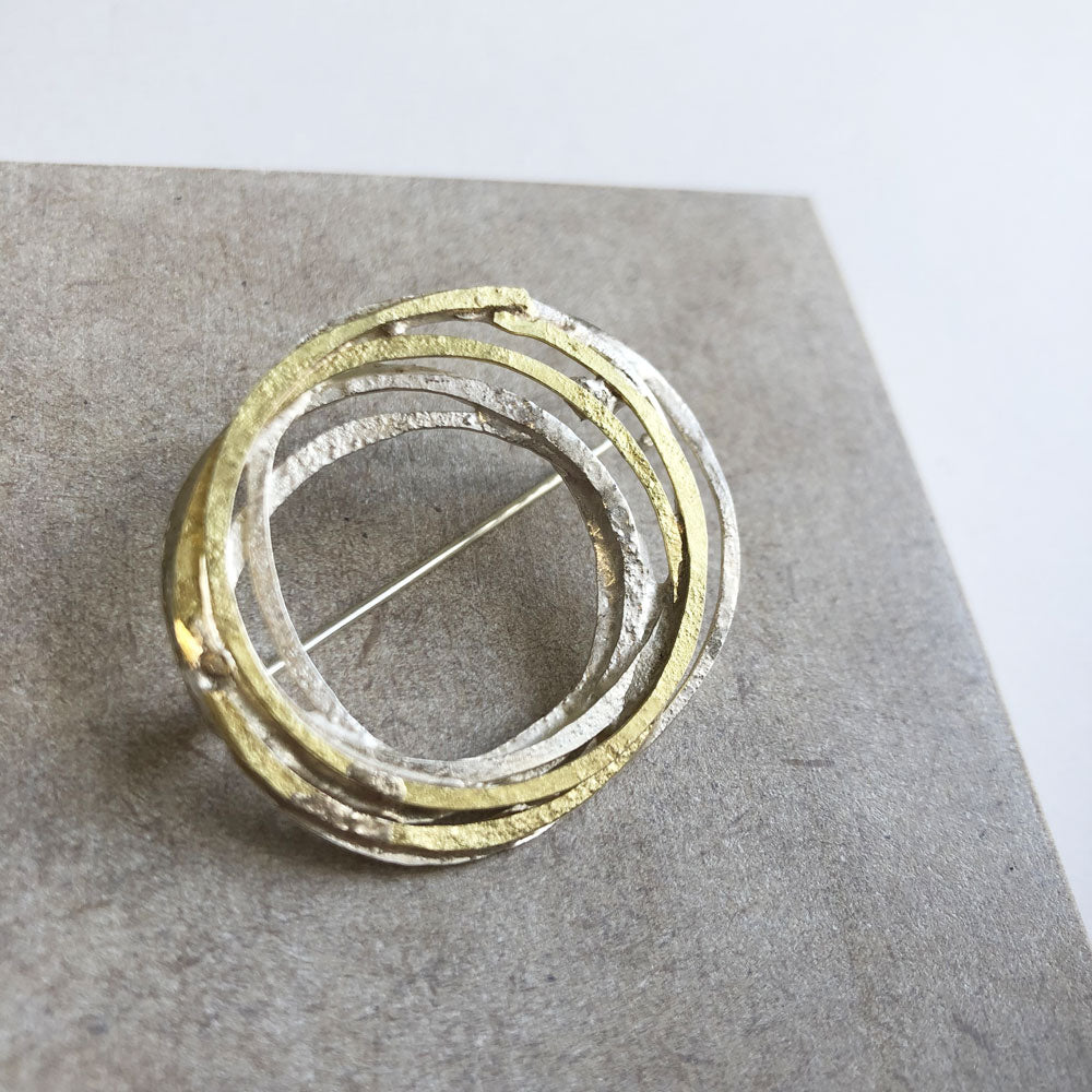 'Wrap' brooch in gold and silver by Shimara Carlow
